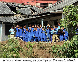 school children waving goodbye in India